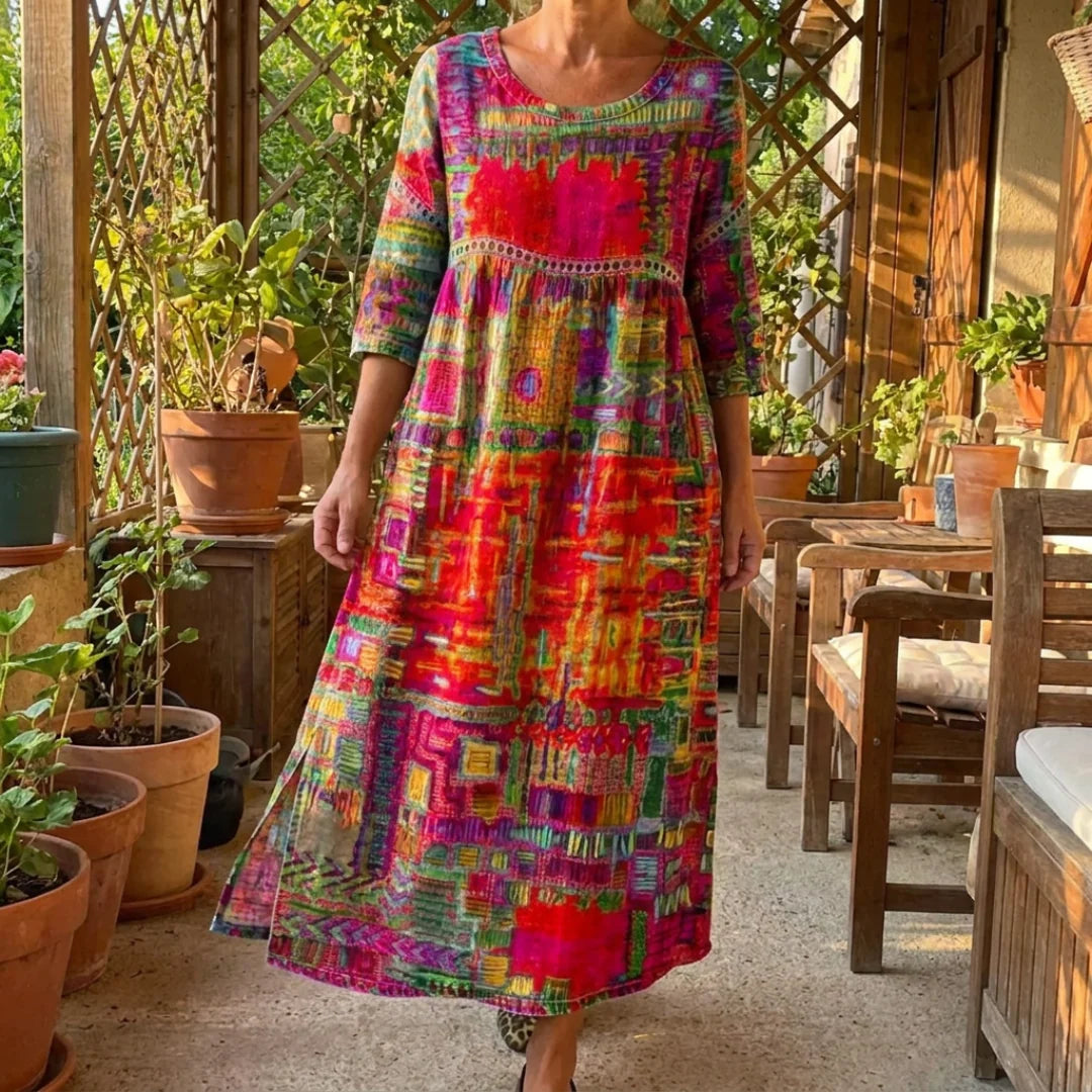 The Alina dress worn on a sunny patio among terracotta pots