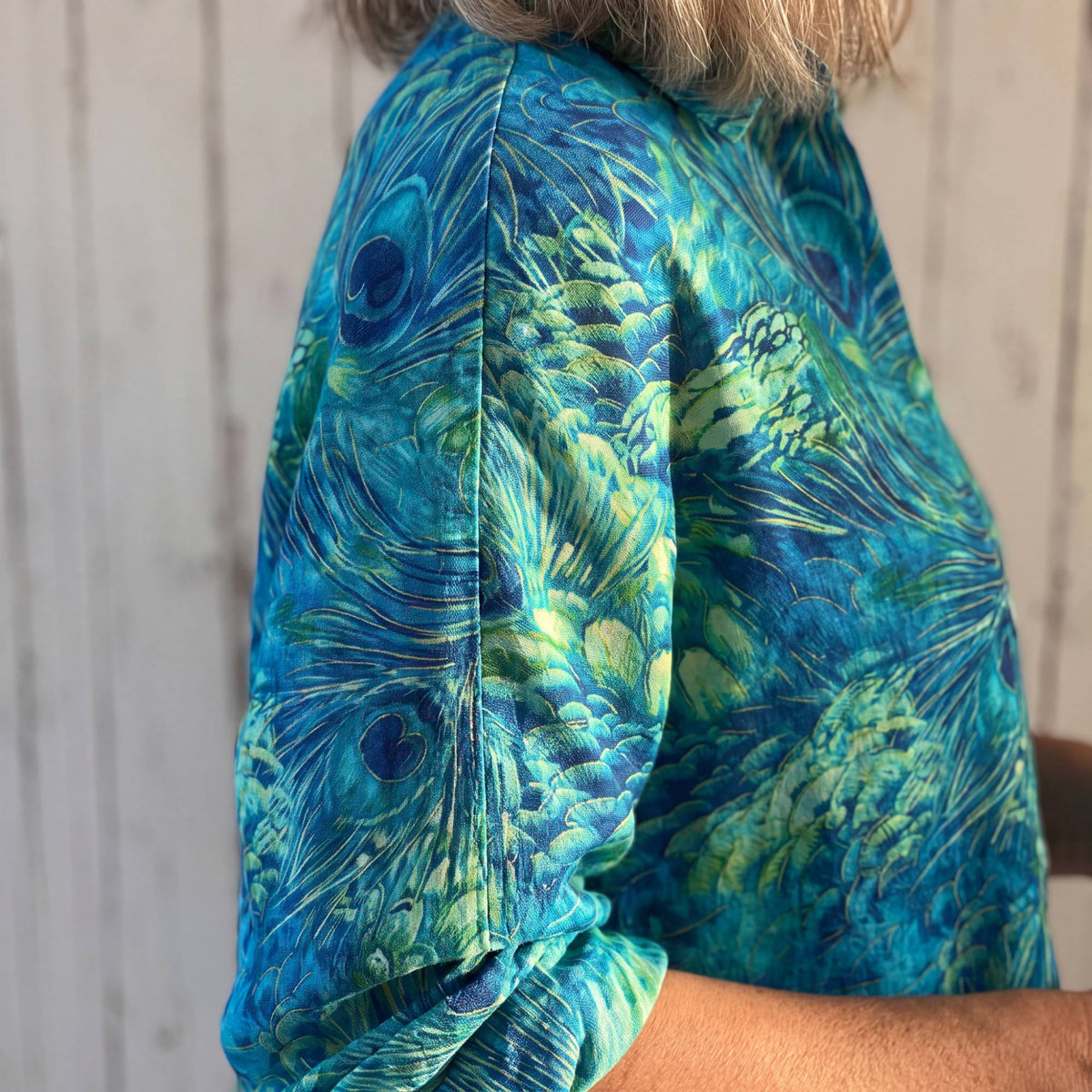 Close-up of the long sleeve of the Florina Grace Blouse, pushed up to the forearm