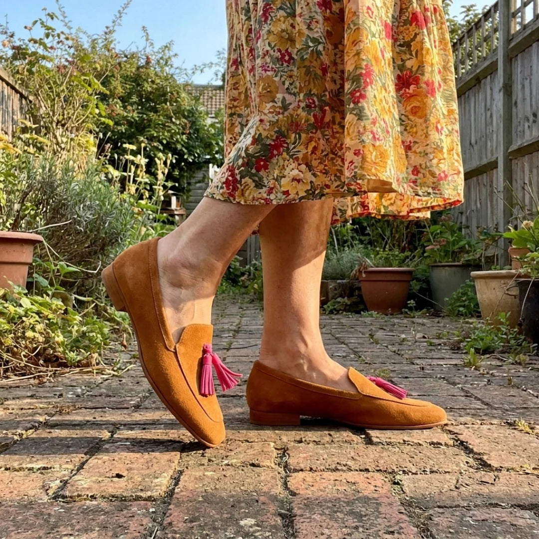 Isadora loafers mid-step in the garden with a floral skirt