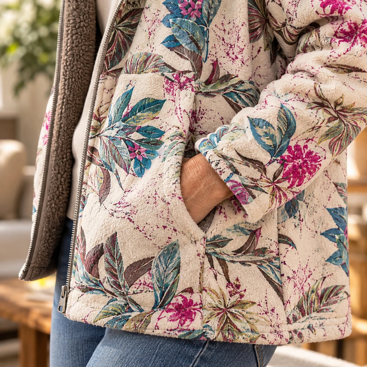 Hand in the pocket of the Melvaris floral fleece jacket, close-up