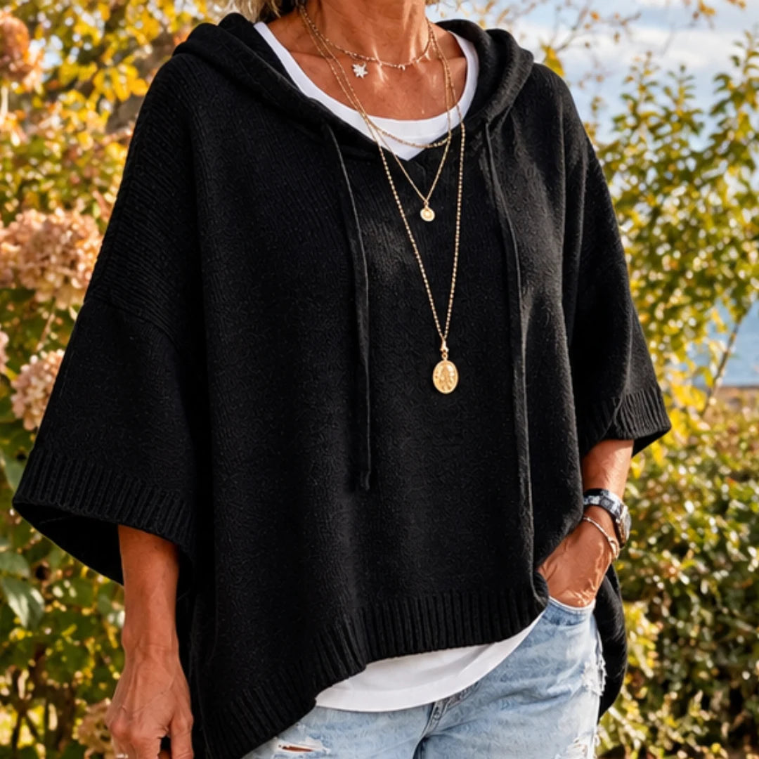 The black poncho worn with jeans