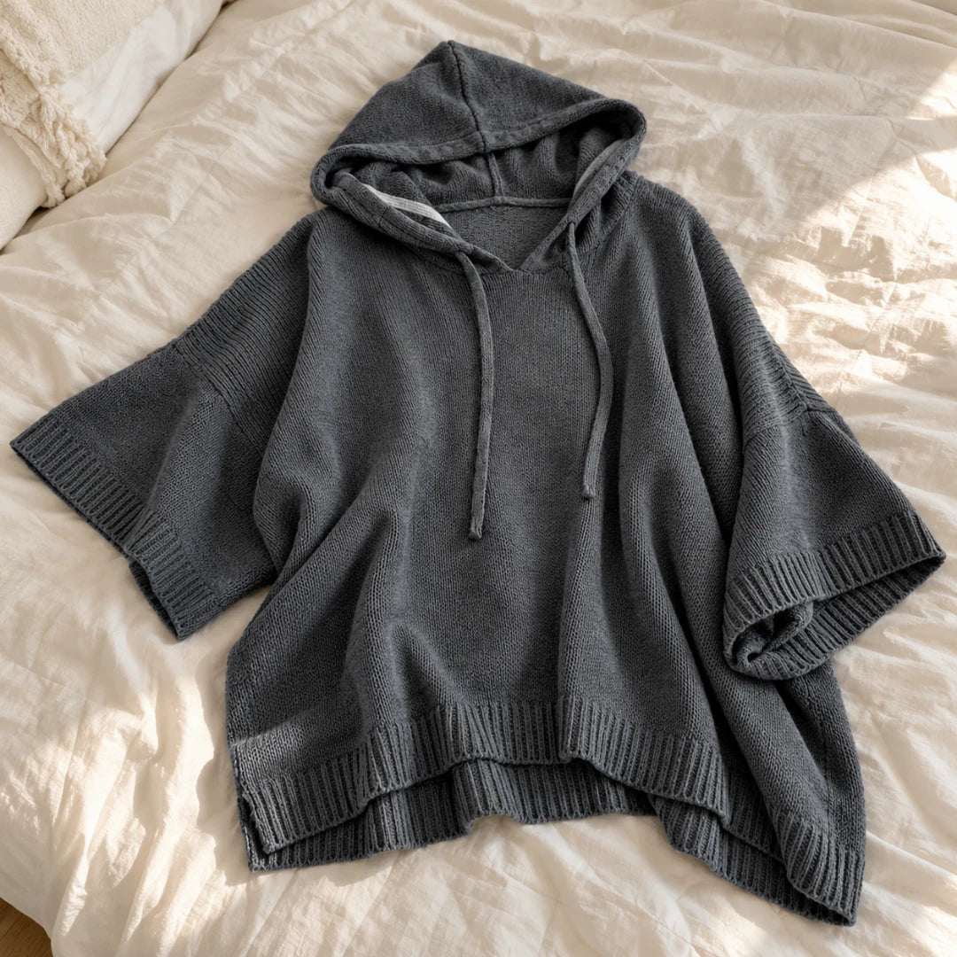 Close-up of the hood, drawstrings, wide sleeves and ribbed knit edges