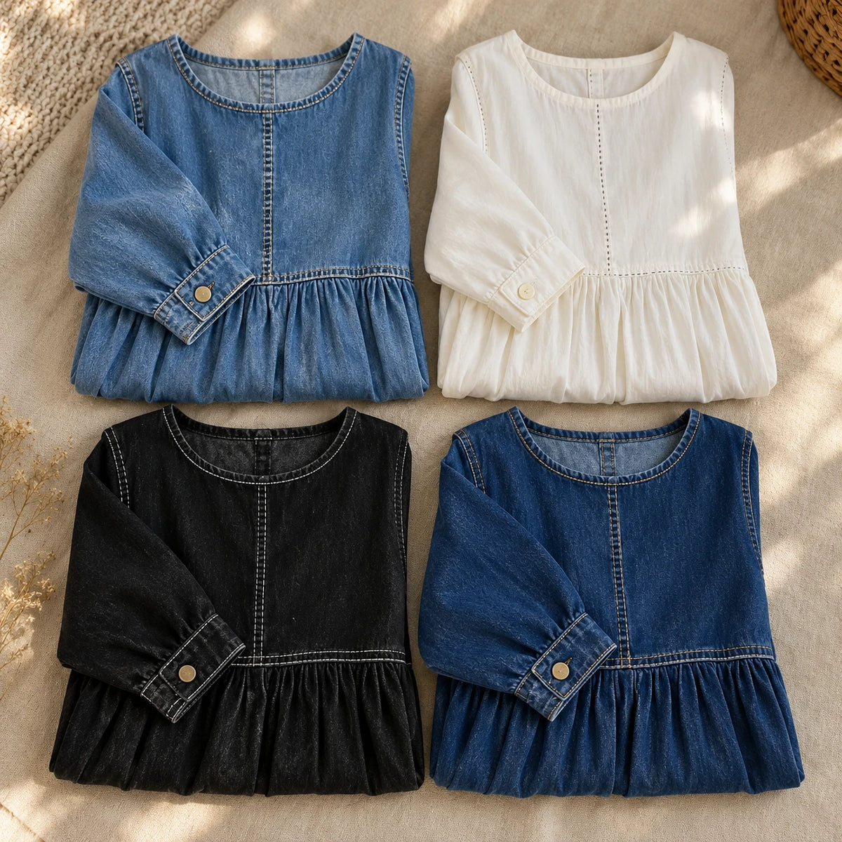 The Zephyrelle dress in all four colors, blue, white, black and navy, laid out on linen